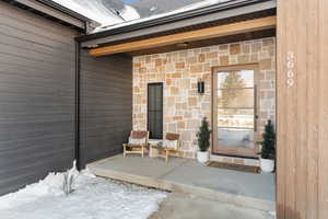 Property entrance featuring stone siding