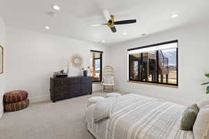 Carpeted bedroom featuring ceiling fan and recessed lighting