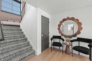 Stairs featuring wood finished floors and baseboards