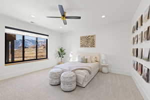 Bedroom with light carpet, a mountain view, ceiling fan, and recessed lighting