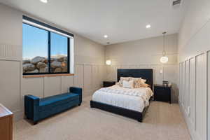 Bedroom with a decorative wall, carpet flooring, and recessed lighting