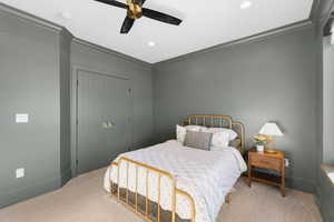 Bedroom featuring carpet floors, crown molding, a ceiling fan, a closet, and recessed lighting