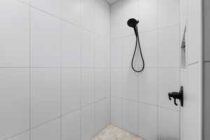 Bathroom featuring a tile shower