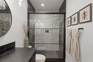 Bathroom with vanity and a stall shower
