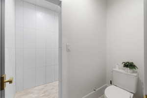 Bathroom featuring toilet and baseboards