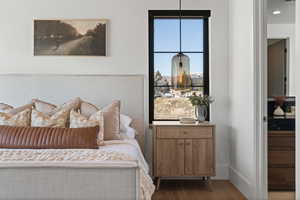Bedroom featuring wood finished floors and baseboards