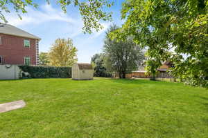 Fenced backyard with a storage unit