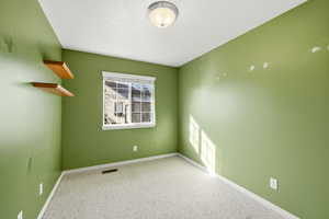 Empty room with carpet and baseboards