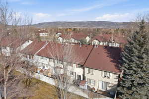Aerial view of property and surrounding area with a mountain backdrop