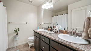Full bath featuring double vanity and a shower with shower curtain