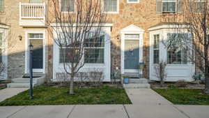 Property entrance with stone siding and brick siding