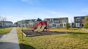 Community play area with a residential view and a lawn