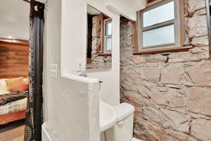 Half bath featuring connected bathroom and toilet