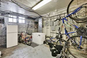 Below grade area featuring freestanding refrigerator