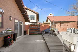 Wooden terrace with a patio area
