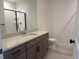 Bathroom featuring vanity and a stall shower