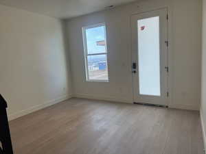 Entryway featuring light wood-type flooring and baseboards