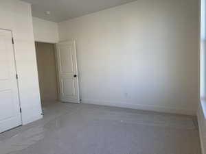 Primary  bedroom featuring baseboards and carpet floors