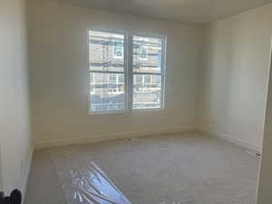 Primary Bedroom featuring light colored carpet