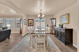 Dining room with arched walkways, a chandelier, recessed lighting, and light tile patterned floors