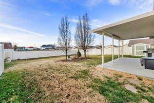 Fenced backyard featuring a residential view and a patio area