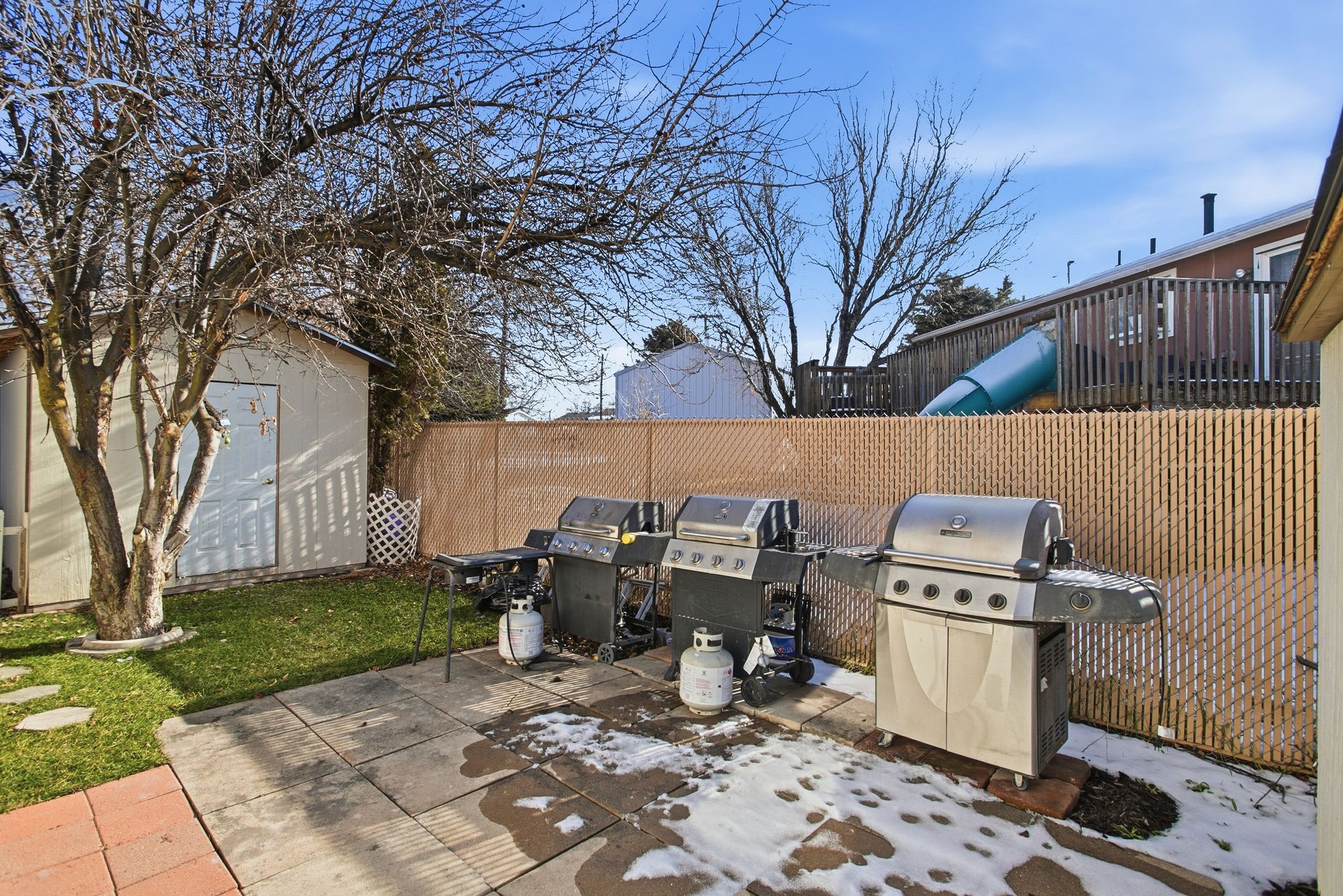 View of patio with a grill