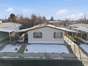 View of property exterior with a carport and a central AC unit