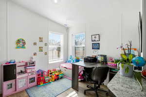 Office with a textured ceiling and light wood finished floors