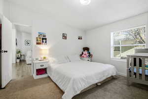 Bedroom with carpet floors and a textured ceiling