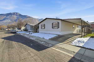 View of front of home featuring a carport, driveway, and a mountain view
