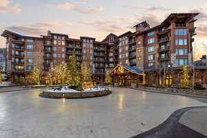 Property at dusk with a view of apartment building / complex