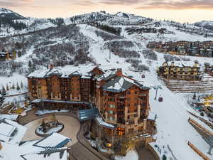 Snowy aerial view featuring a mountain view