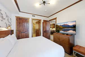 Bedroom with ornamental molding, a closet, and carpet floors