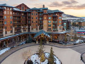 Snow covered building with a view of apartment building / complex