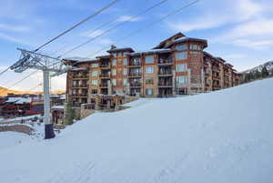 Snow covered property featuring a view of apartment building / complex