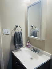 Bathroom featuring vanity and a textured wall