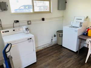 Communal laundry room featuring washing machine and clothes dryer