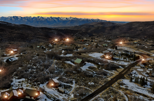 Snowy aerial view with a mountain view and a residential view