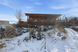 View of front of home featuring a wooden deck