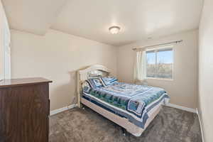 Carpeted bedroom with baseboards