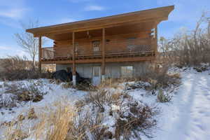 Snow covered property with a deck