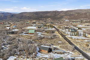 View of mountain backdrop featuring nearby suburban area