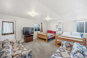 Bedroom featuring light carpet and baseboards
