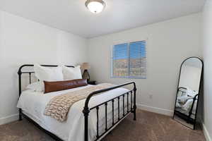Carpeted bedroom featuring baseboards