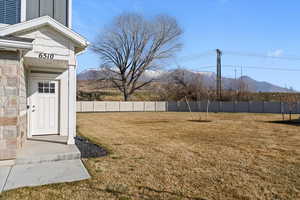 Fenced backyard with a mountain view