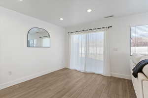 Kitchen Table Area with light wood-style floors and recessed lighting