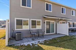 Back of property with a patio and stucco siding