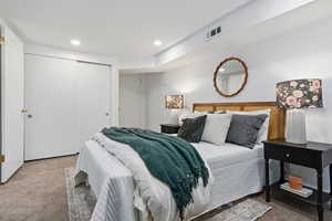 Carpeted bedroom featuring a closet and recessed lighting