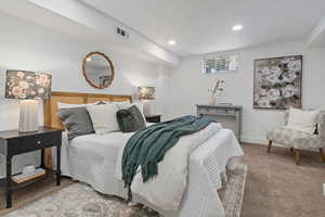 Carpeted bedroom with baseboards and recessed lighting