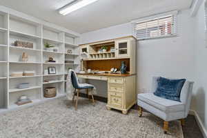 Home office featuring light colored carpet